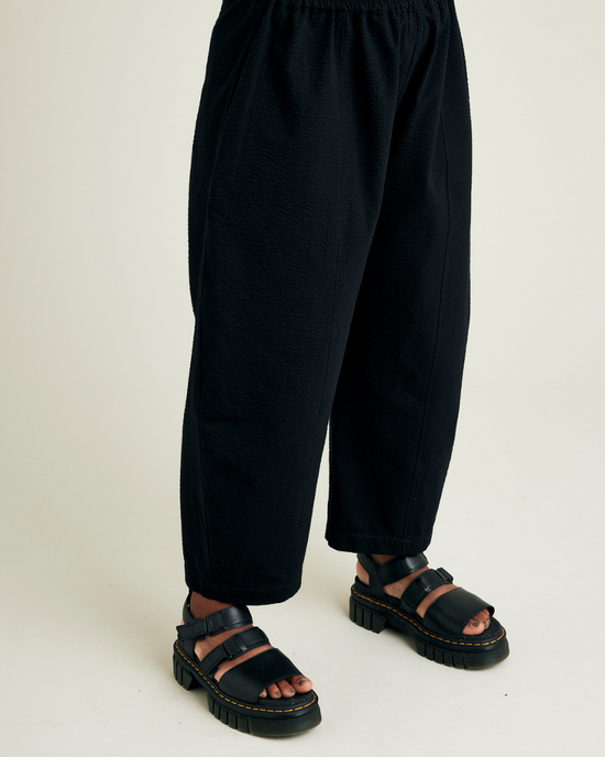 model wears black seersucker mabel trousers right