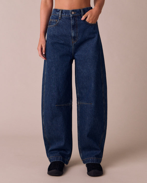 model wears echo mid wash denim jeans front