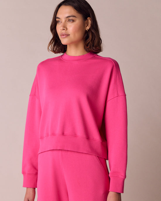 model wears eden hot pink fleeceback jersey jumper