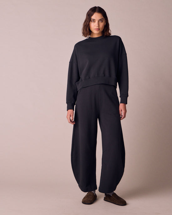 model wears helina washed black jersey trousers right