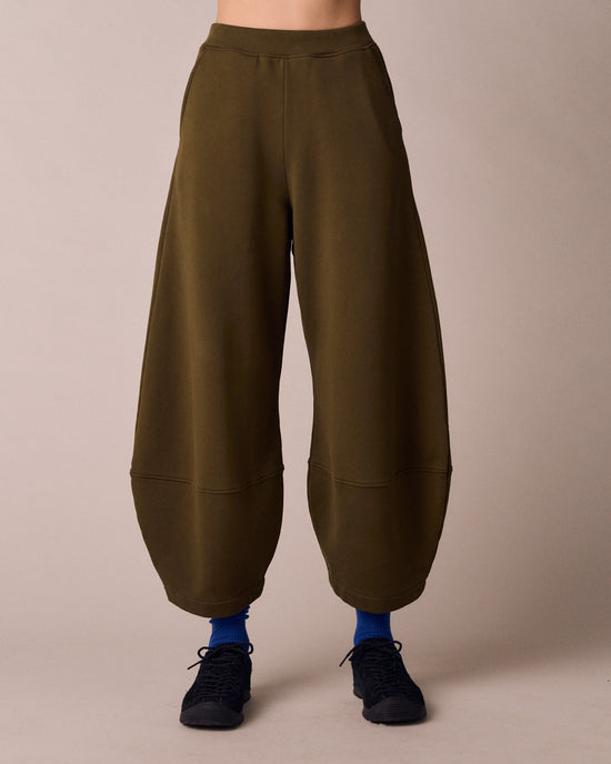 model wears pascale earth green jersey trousers front