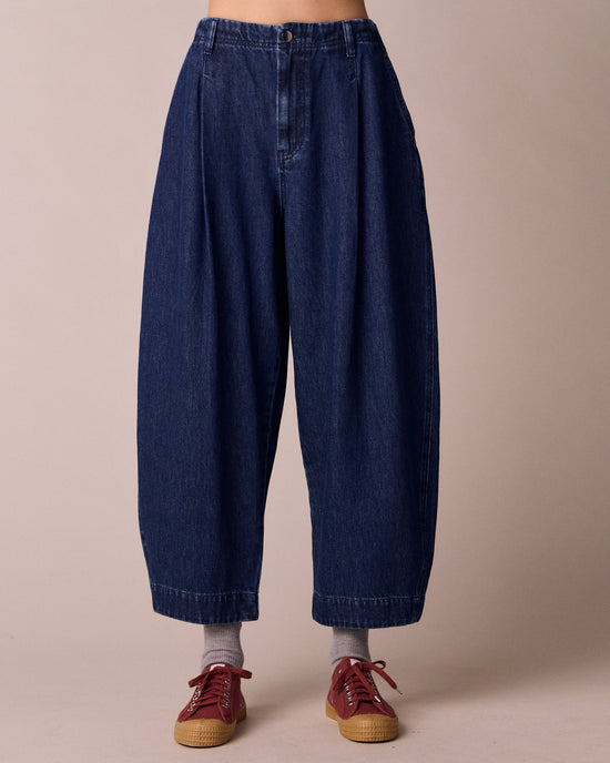 model wears veda dark wash denim jeans front