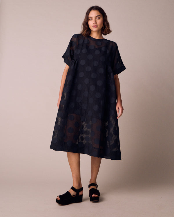 model wears zyla black sheer spot dress