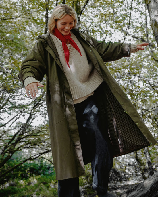 model wears indy dark olive coated cotton jacket