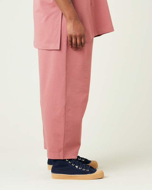 model wears dusty pink huxley jersey trousers right