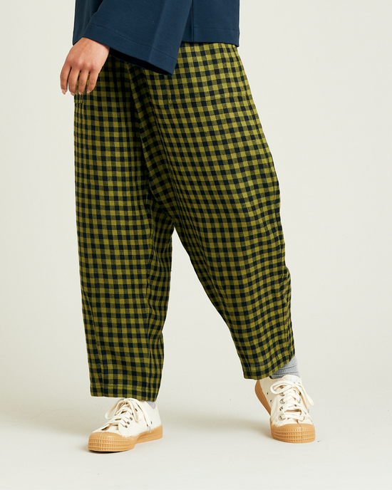 model wears green gingham huxley trousers left