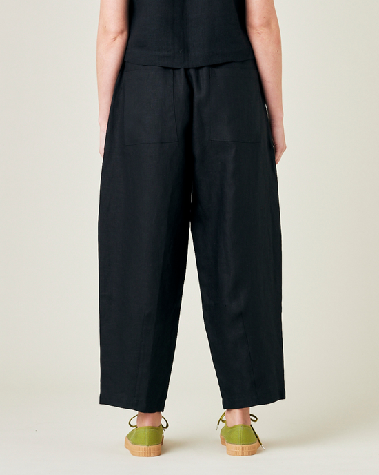 model wears black linen huxley trousers 