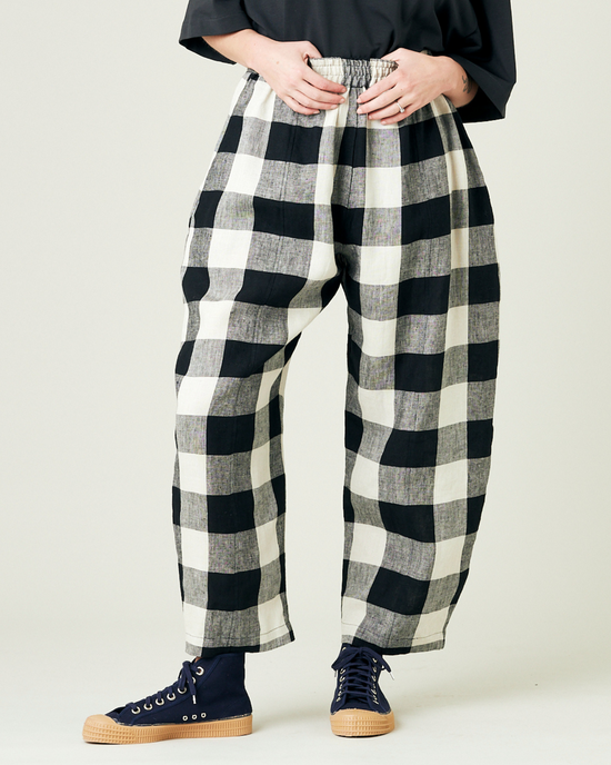 model wears stone and black mega check linen mabel trousers from the front