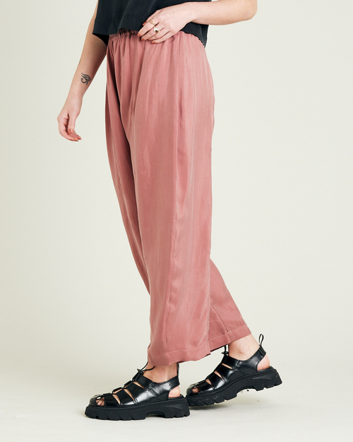 model wears dusty pink cupro trousers left