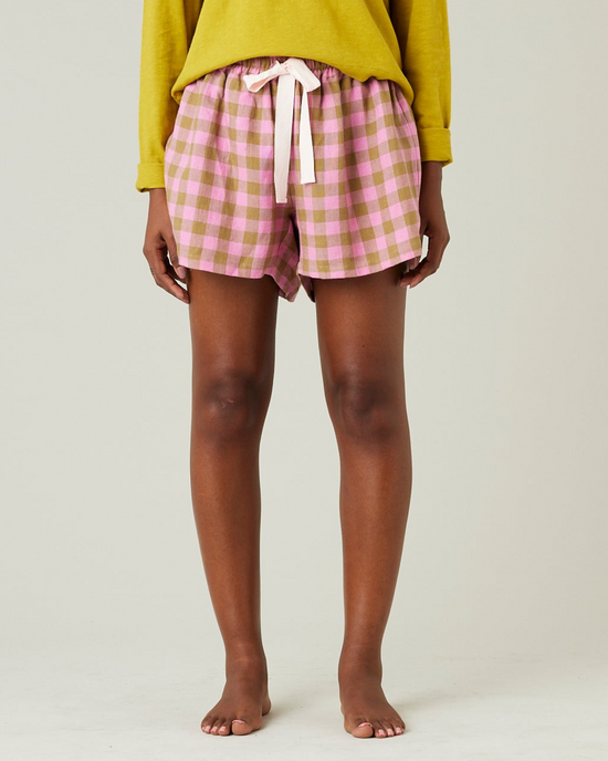 model wears pink and green check bed shorts