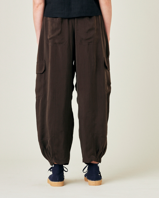 model wears espresso cupro sylvie trousers back