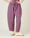 model wears pink and black gingham linen mabel trousers from the front