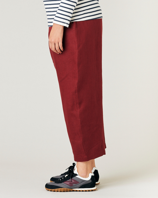 model wears brick linen mabel trousers left