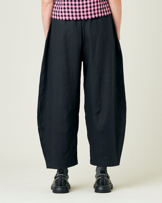 model wears black linen daisy trousers back