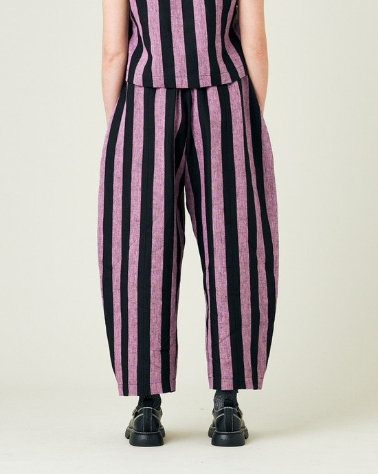 model wears pink and black stripe linen mabel trousers from the back