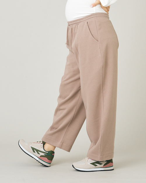 model wears jenny jersey latte trousers left