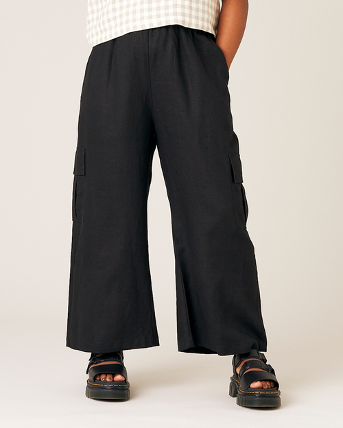 model wears black orla linen trousers front