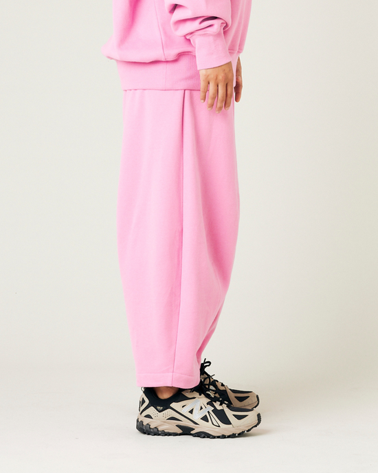 model wears pink daisy jersey trousers right