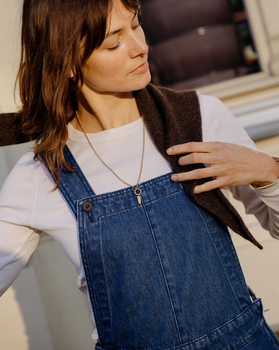 model wears gwynne mid blue denim dungerees
