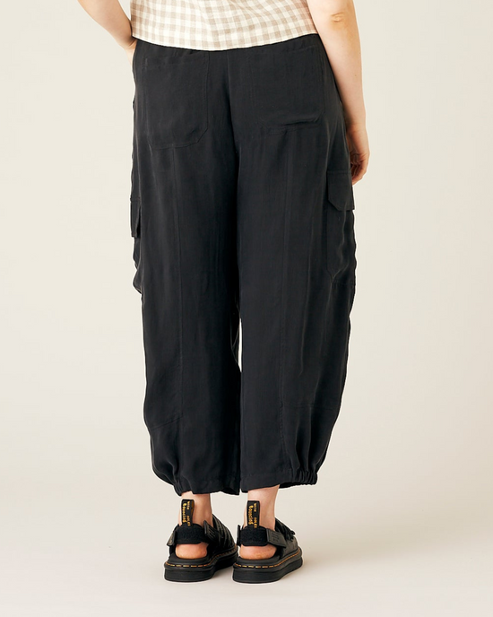 model wears black cupro sylvie trousers back