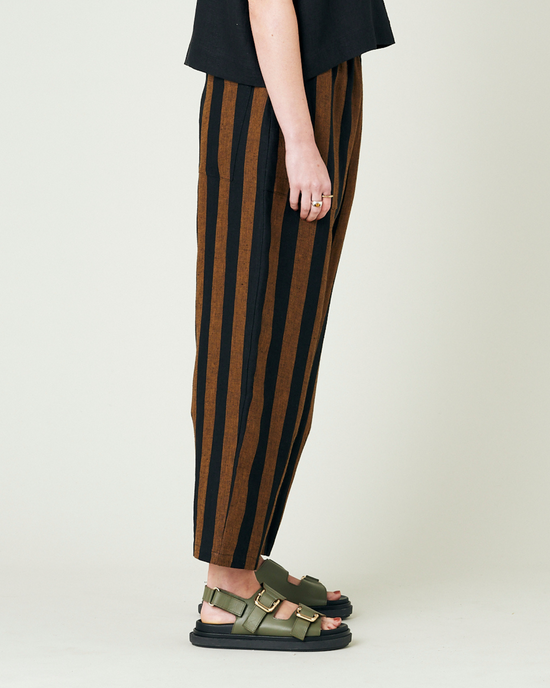 model wears rust stripe huxley trousers right