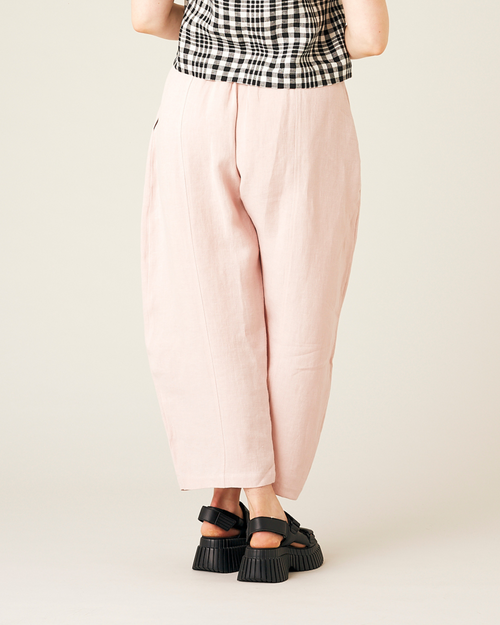 model wears rose linen mabel trousers back