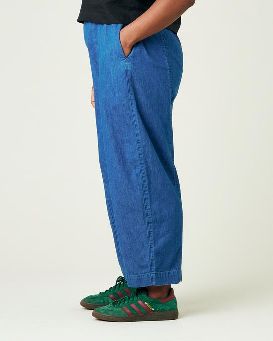 model wears mid wash chambray mabel trousers left