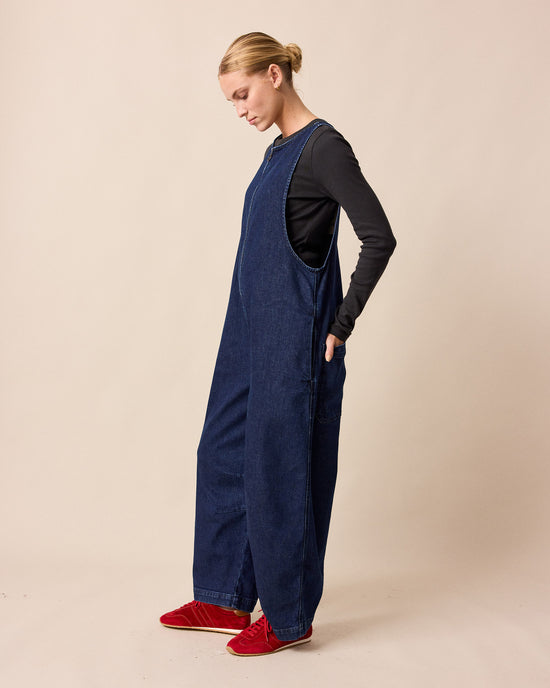 model wears ada dark blue denim jumpsuit