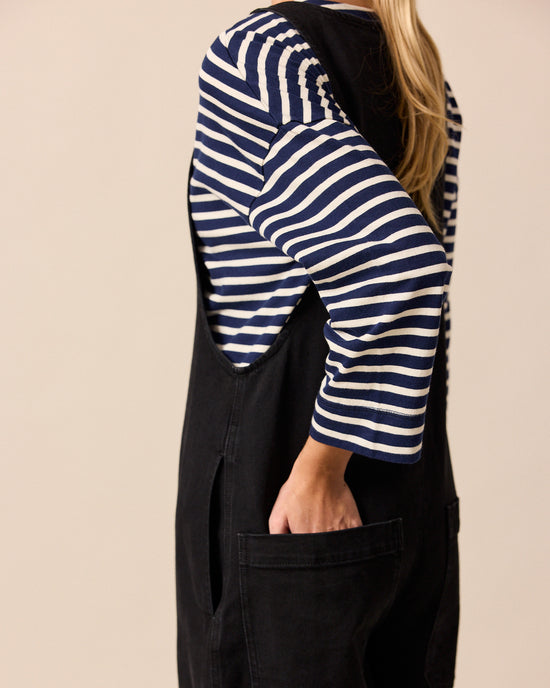 model wears ada black denim jumpsuit