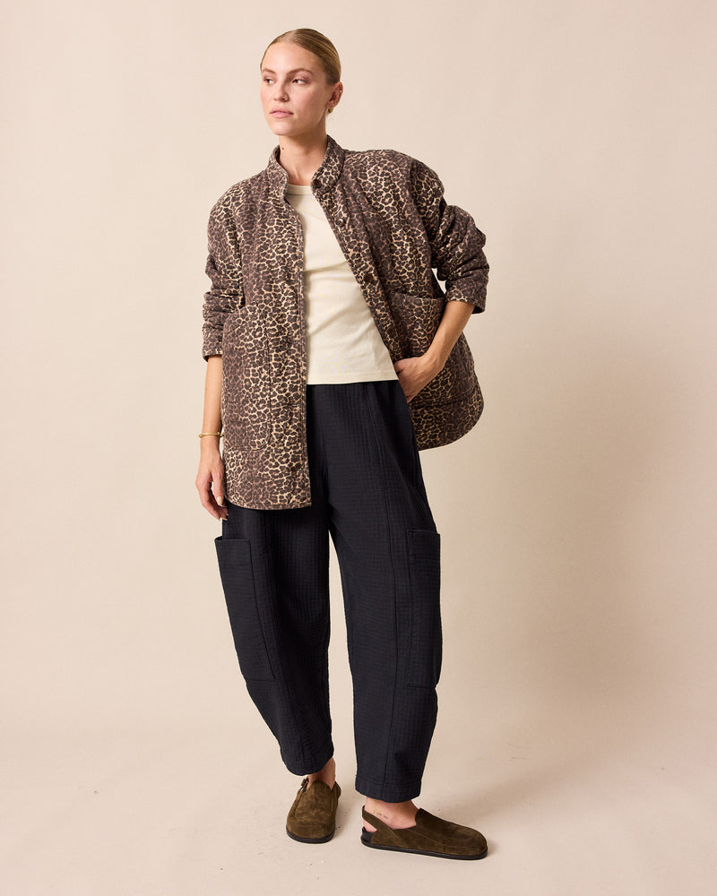 model wears amala black quilted cotton trousers right