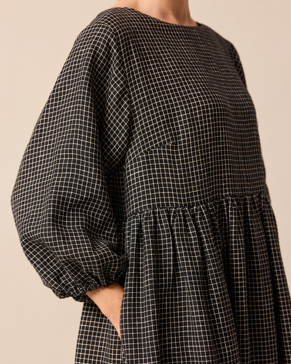 model wears berlin black mini grid linen dress