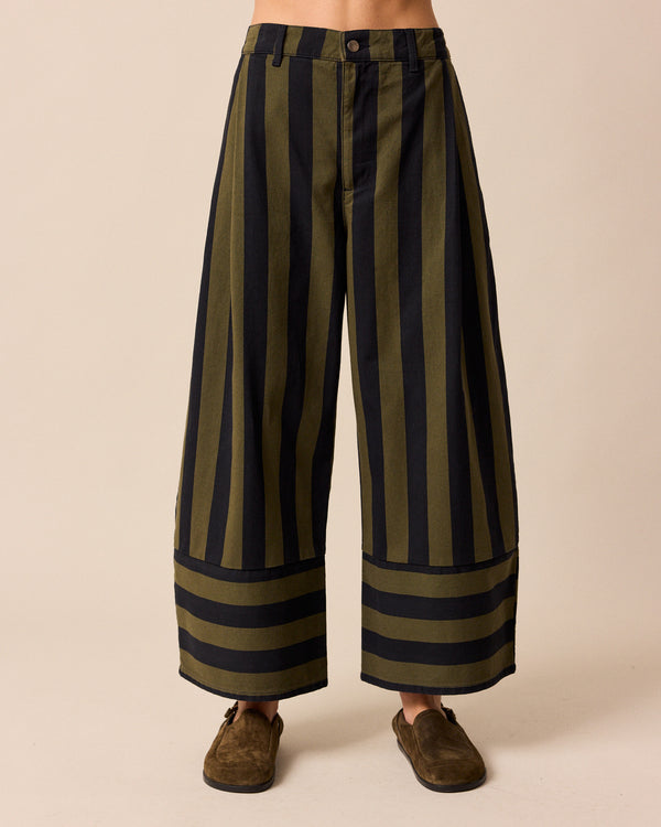 model wears blair olive and black stripe denim trousers front