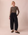 model wears daisy black cord trousers right