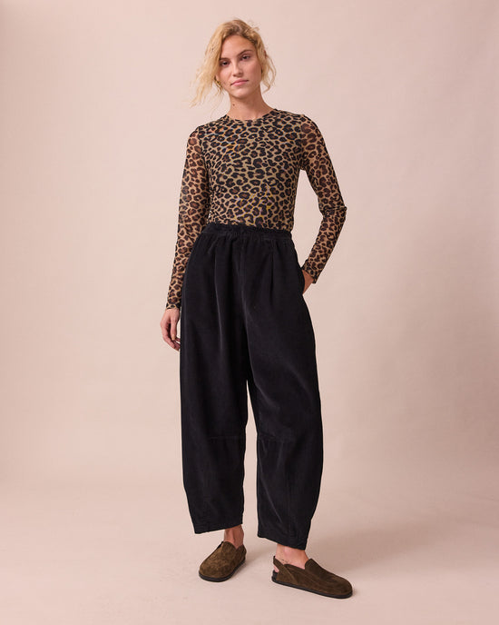 model wears daisy black cord trousers right