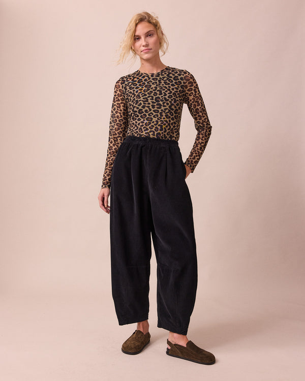 model wears daisy black cord trousers right
