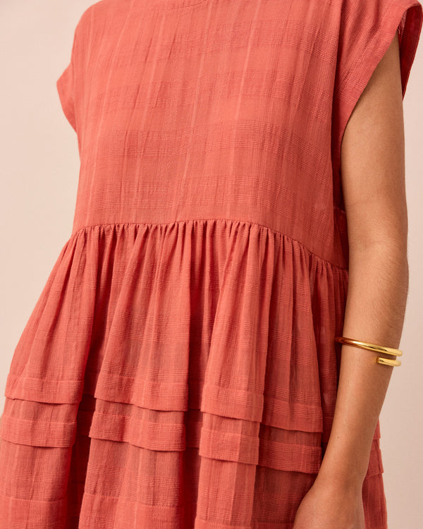 model wears ella terracotta cotton gauze dress