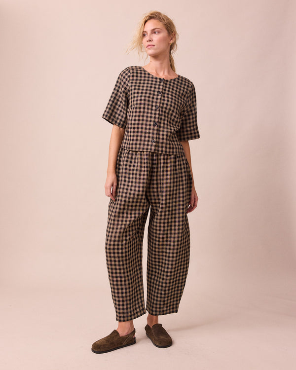 model wears evelyn coffee gingham linen top front