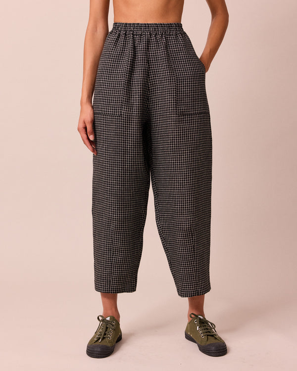 model wears huxley black mini grid linen trousers front