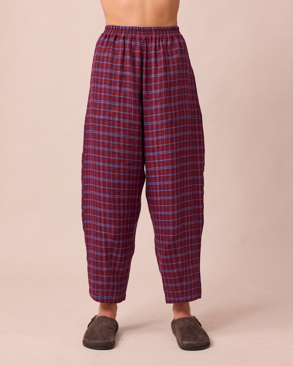 model wears huxley mulberry plaid linen trousers front
