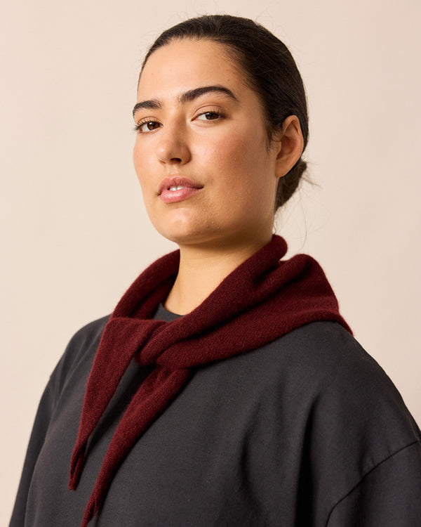 model wears dark burgundy knitted neckerchief