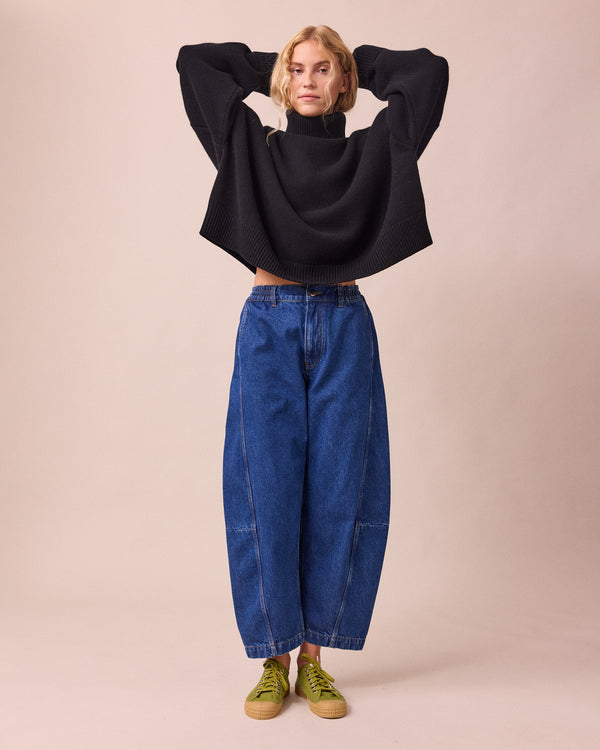 model wears tori mid blue wash denim jeans right