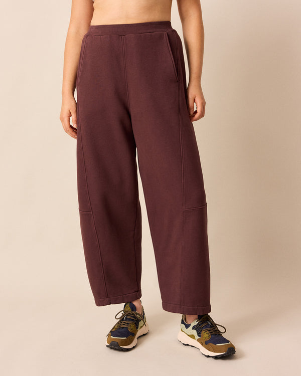 model wears lyra burgundy fleeceback jersey trousers front
