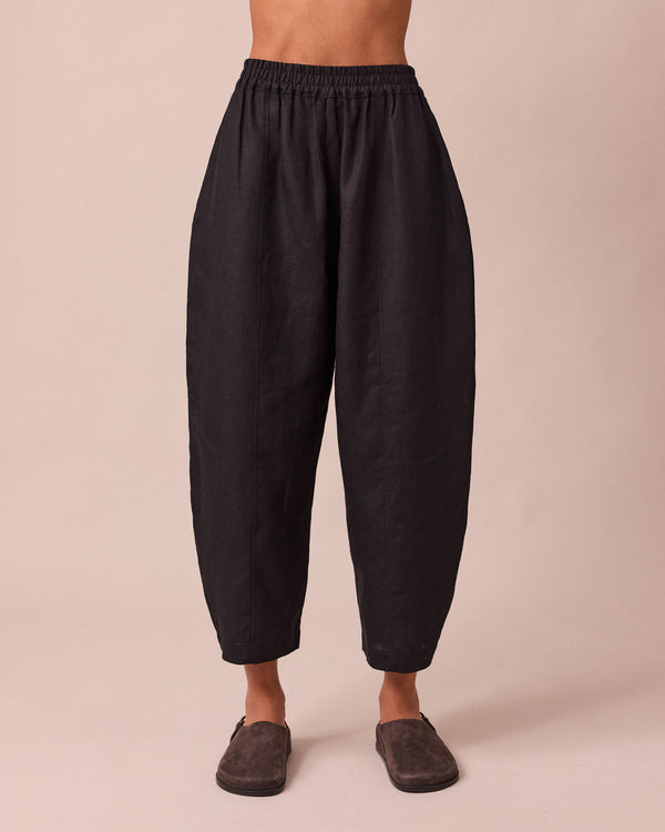 model wears mabel black linen trousers front