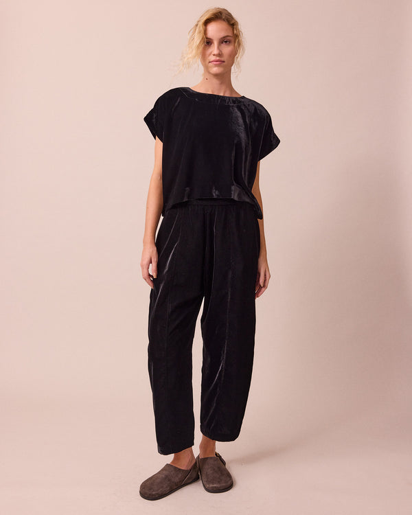 model wears mabel black velvet trousers right