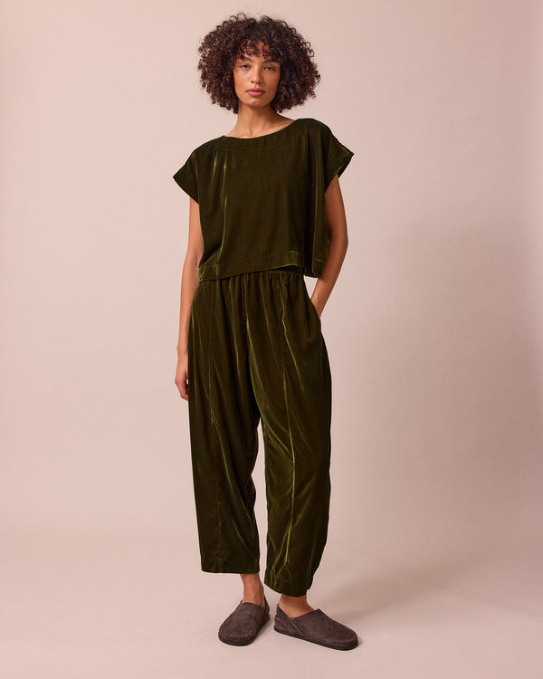 model wears mabel moss green velvet trousers right