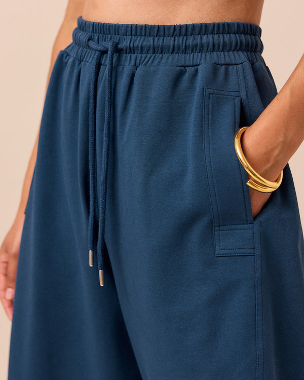 model wears madi french navy jersey trousers right