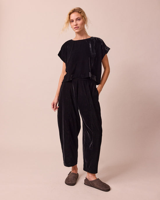 model wears polly black velvet top