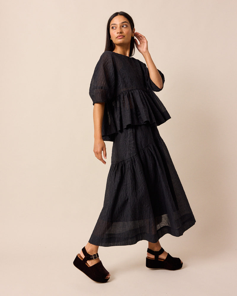 model wears priya black organza top