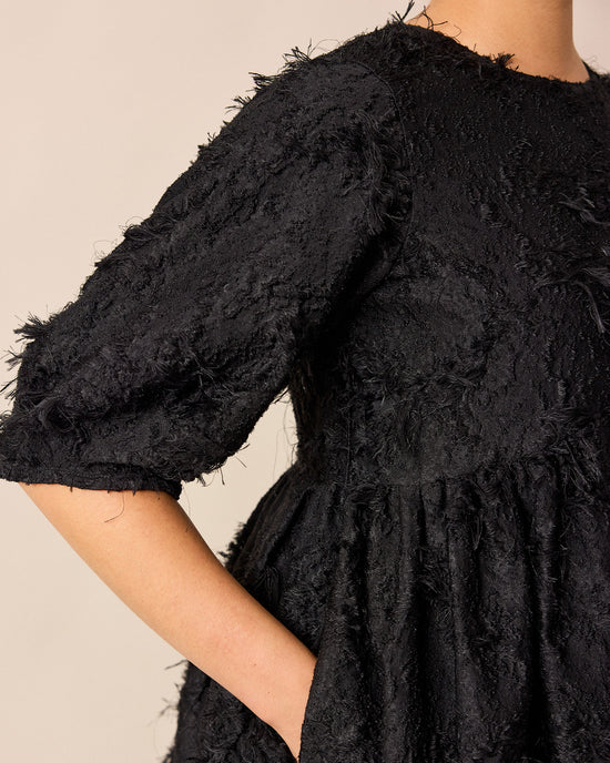 model wears prue black tufted dress