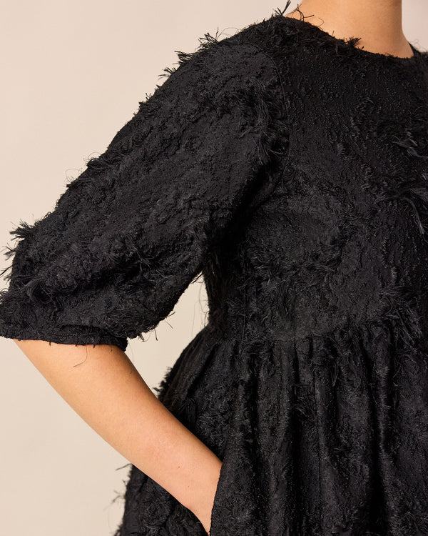 model wears prue black tufted dress